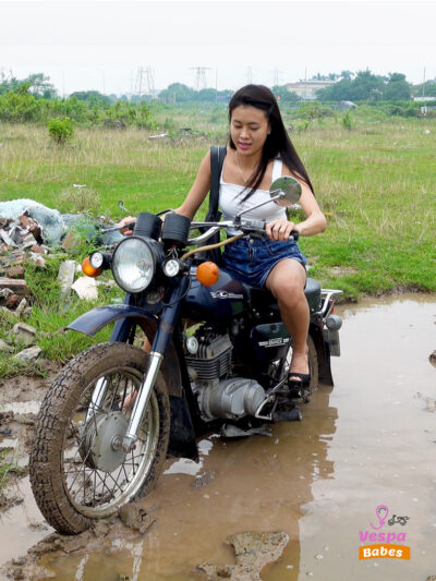 Miss kim is stuck in a puddle - the motorbike is smoking
