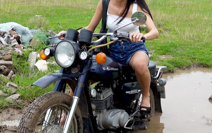 Miss kim is stuck in a puddle - the motorbike is smoking