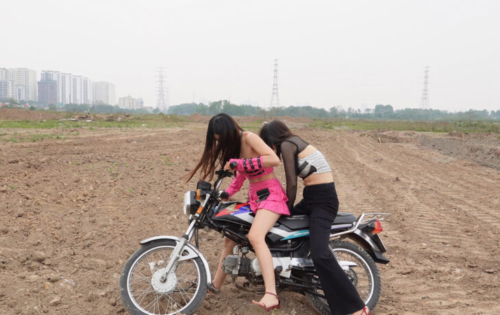 Two Girls Learn To Ride An Old Honda Motorcycle On A Rough Dirt Field